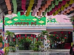 Scenic view of Suoi Tien Park in July 2023 with lush greenery and visitors walking on the path