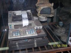 Burnt cash register with melted monitor at Ycuá Bolaños supermarket fire memorial in Asunción Paraguay