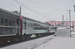 Canadian National Electric Multiple Unit suburban train cars in two paint schemes at Cartierville stop in Montreal