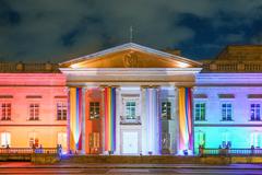 Commemorative event for LGBTIQ month with colorful rainbow flags and people gathered in celebration