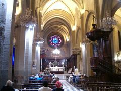 Interior nave of Toulon Cathedral with wooden pews and arched ceiling