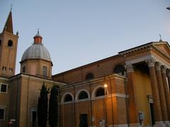 Exterior view of the Cathedral of Forlì, showcasing its historical architecture under a clear blue sky