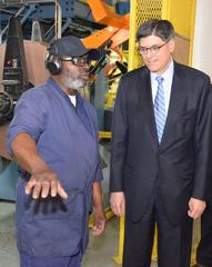 Secretary Lew visiting the Denver Mint with machine operator Freddie Smith giving a tour