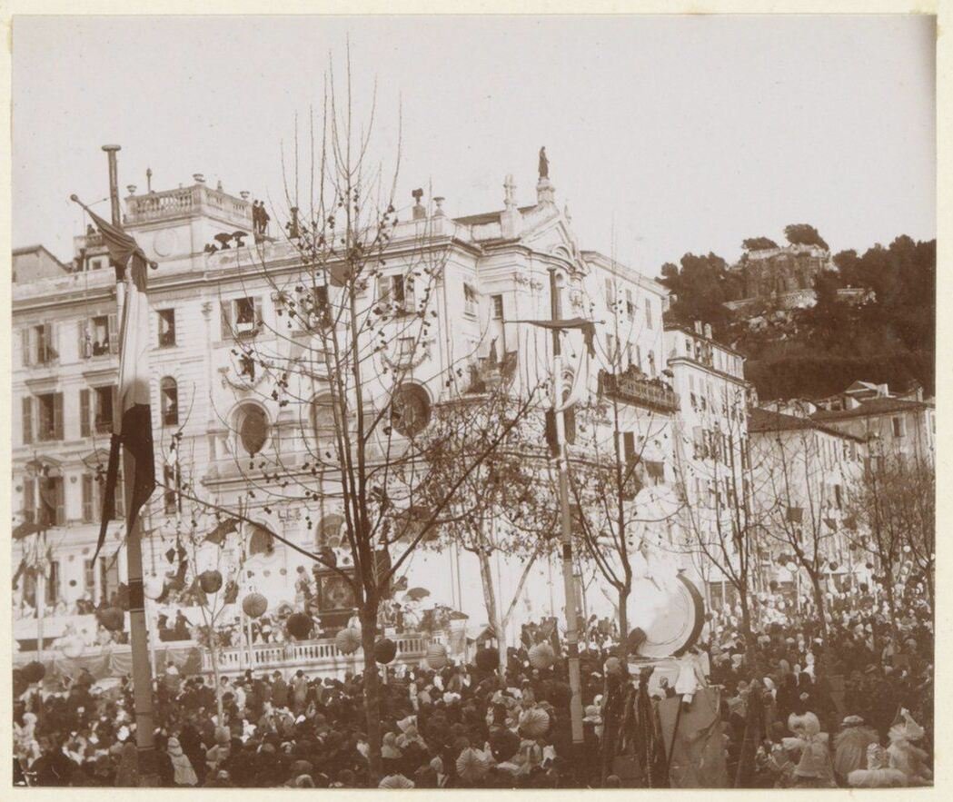 Crowd gathered in front of a building during a festive day on the coast of South France around 1900 1910