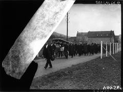 Funeral of Claude Monet with mourners gathered around the casket