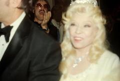 Mae West on Paul Novak's arm with Lars Jacob in background at Cinerama Dome Los Angeles California 1978