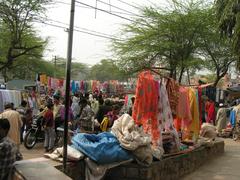 Busy street market in Nizamuddin area with shops and people