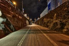 Night view of Baana cycling and pedestrian path in Helsinki with illuminated buildings and streetlights