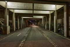 Baana walking and cycling path in Helsinki illuminated at night with cityscape