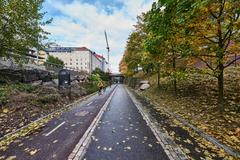 Baana cycling and pedestrian path in Helsinki with city buildings and greenery