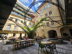 Interior of L'Osteria Pizza restaurant in Prague with wooden tables and chairs