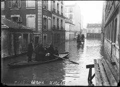 Flooded street in Paris with people sailing in boats during the 1910 flood in 15th arrondissement on Rue Lacordaire
