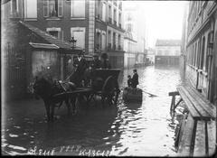 Flooded street in Paris 15th arrondissement with carts and boats on Rue Lacordaire during January 1910 floods