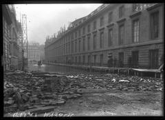 Wood debris scattered on the ground on Rue de Bourgogne in Paris after the 1910 flood, 7th arrondissement