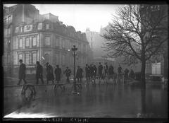 1910 flood on Avenue Montaigne in Paris with people walking on elevated wooden planks