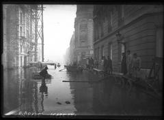 Flooding on Rue de l'Université in Paris 7th arrondissement January 1910 with military personnel and boats on flooded street