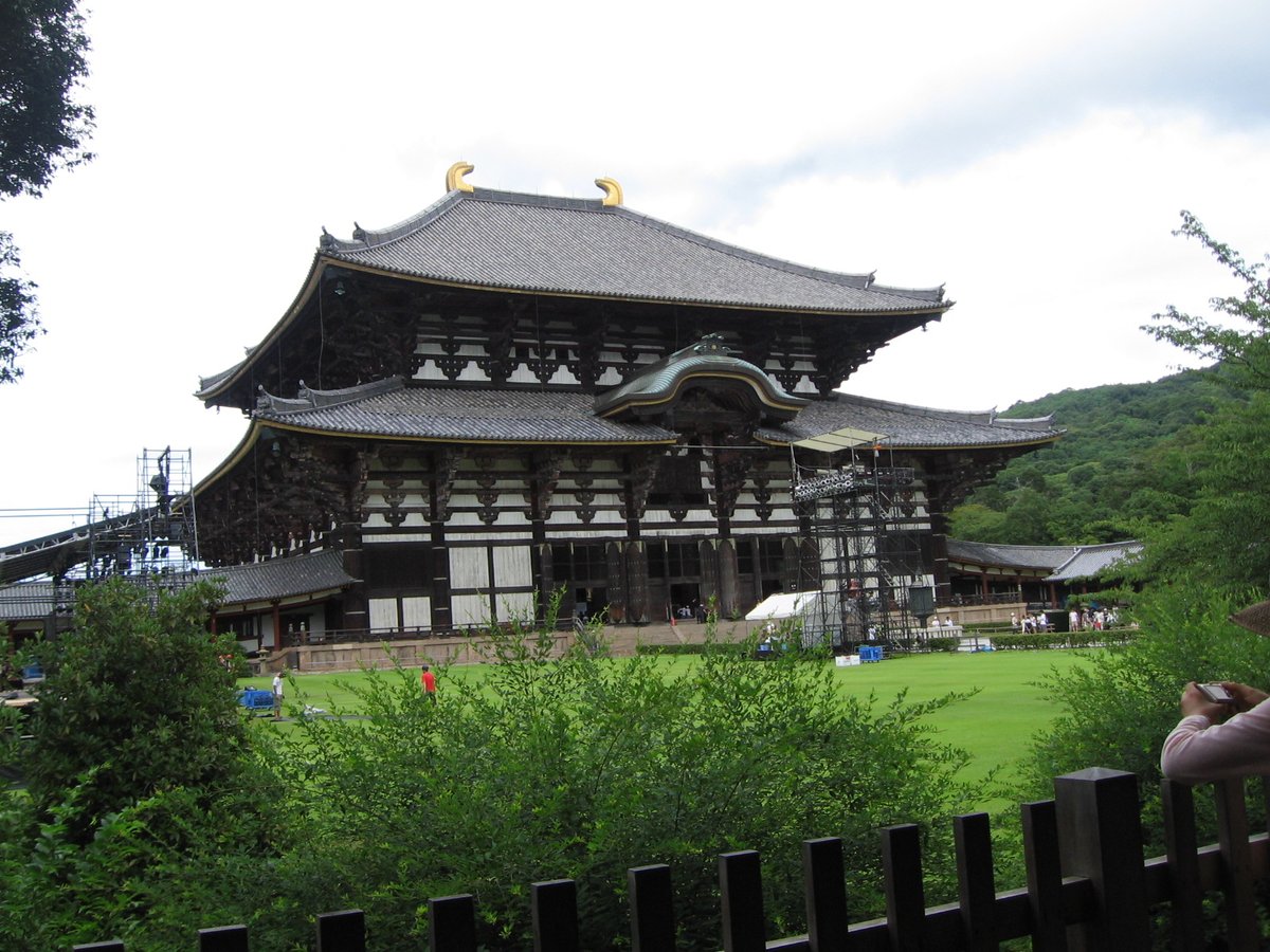 Traditional Japanese garden with a pond, stone lanterns and lush greenery in Nara, Japan during August 2009