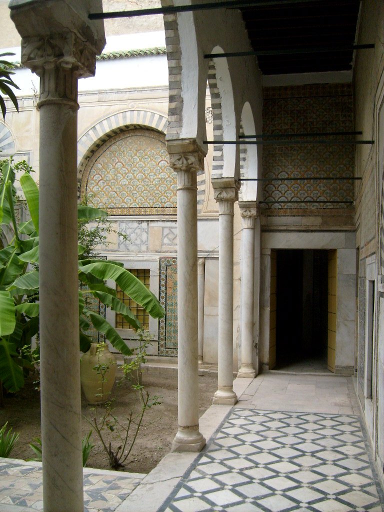 Protected monument courtyard in Tunisia with traditional architecture and trees
