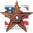 Rustic wooden barnstar mounted on a grey wooden wall