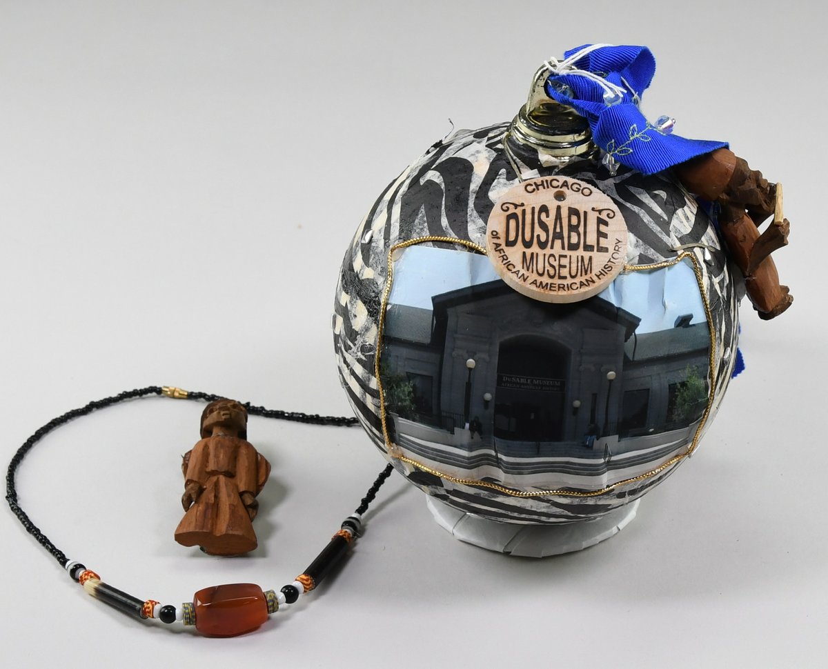 2009 White House Holiday Ornament featuring the Dusable Museum of African American History with zebra print, wood figures, and beaded necklace