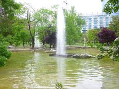 Panoramic view of Parque de Doña Casilda Iturrízar in Bilbao with lush greenery, walking paths, and urban surroundings