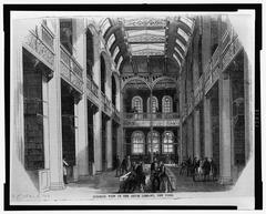Interior view of the Astor Library in New York with wooden bookshelves and reading tables