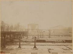Historic view of Esplanade des Invalides in Paris from 1899 showing a wide street and architectural buildings under cloudy sky
