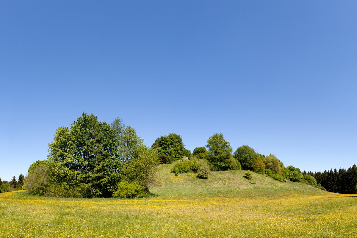 Perlacher Mugl hill in Munich, Germany with green meadow and city skyline