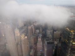Low clouds over Lower Manhattan skyscrapers at night including Woolworth Building
