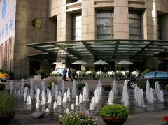 Far Eastern Plaza North Fountain with water jets and surrounding urban buildings