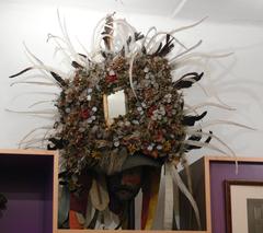 Altartuxer traditional mask with felt hat, wooden face, horsehair wig, artificial flowers, sequins, gamecock feathers and mirror from Rum, Tirol, 1897