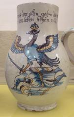Majolica jug featuring the motif The eagle of the Holy Roman Empire triumphs over a fallen Turk, dated 1687