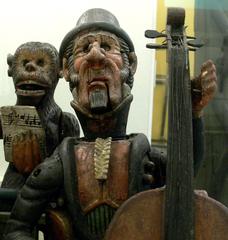 Cellist wearing a top hat playing in the Mechanical World Theater circa 1850
