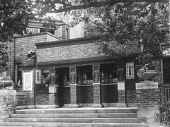 Exterior view of Frank Lloyd Wright Home and Studio with a wooden porch and surrounding greenery