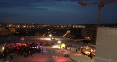 Night event on the terrace of La Friche with people and city lights
