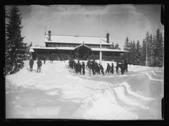 Snow-covered Frognersæteren Sportshalden building in Oslo surrounded by bare trees