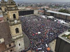Protest march supporting reforms with large crowd holding banners and flags