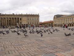 Plaza Bolivar surrounded by historic buildings with a statue in the center under a clear sky
