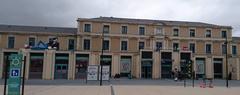 Angouleme train station exterior with railway tracks and overcast sky