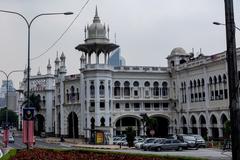 The historic Kuala Lumpur Railway Station with Moorish architecture under a blue sky