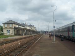 Platforms and tracks of Saintes railway station in Charente-Maritime, France with a mainline train from Bordeaux to Nantes
