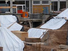 Construction site at Karlsruhe Institute of Technology with yellow cranes and building in progress