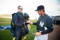 Special Warfare Operator Isaiah Maring of the U.S. Navy Leap Frogs presenting game ball to New York Yankees coach Ron Guidry at Steinbrenner Field