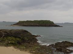 Le Grand Bé tidal island with historic buildings and lush greenery in Saint-Malo, France