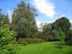 Oslo Botanical Garden entrance with lush green trees and pathway