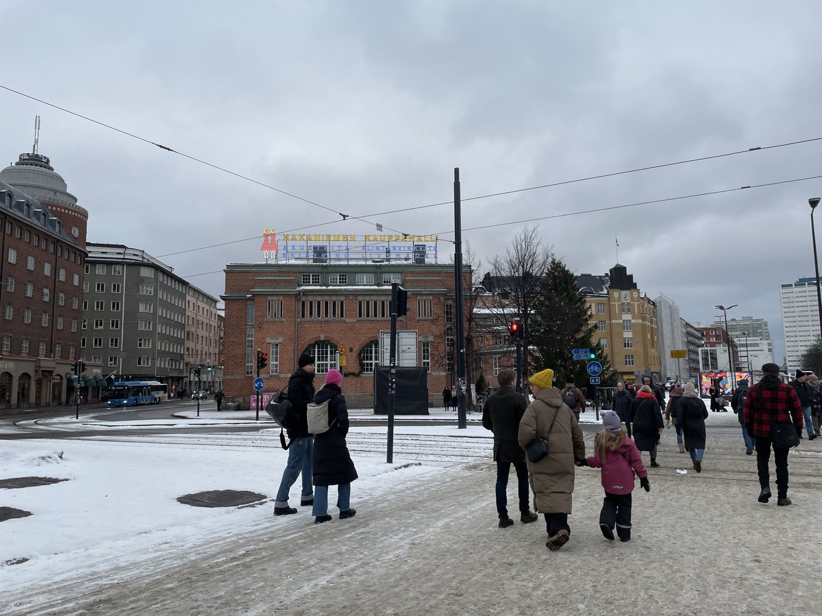 Hakaniemi market hall decorated with a Christmas tree in winter