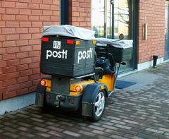 Finnish mailman's electric mail vehicle on Juustenintie in Helsinki