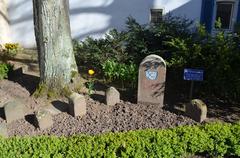 Historic boundary stones in Frankfurt-Zeilsheim under bright blue sky
