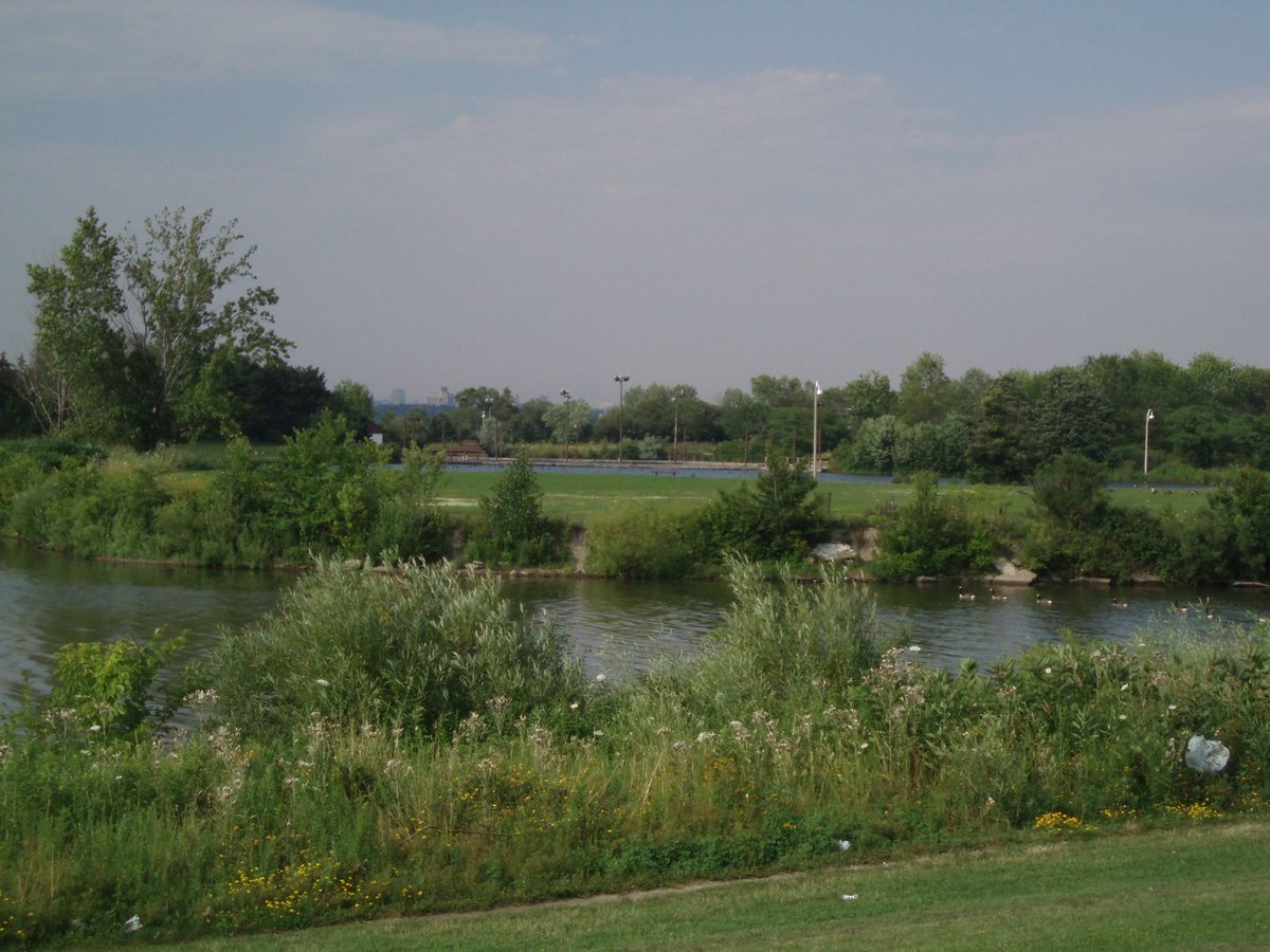 Scenic view of Humber Bay Park with water, greenery, and cloudy sky