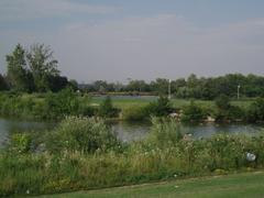 Scenic view of Humber Bay Park with water, greenery, and cloudy sky
